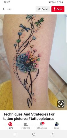 a tattoo on the leg of a woman with flowers and dragonflies around her neck