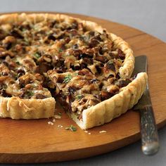 a close up of a pie on a cutting board