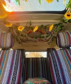 the sunflowers are hanging from the ceiling in the back of a van with striped seats