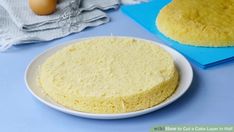 a cake sitting on top of a white plate next to a blue napkin and an egg