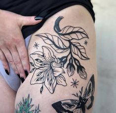 a woman's thigh with flowers and butterflies on it