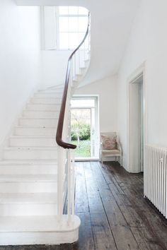 a white staircase leading up to the second floor