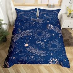 a blue comforter with white stars and sunflowers on it