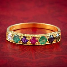 A sweet Victorian-inspired acrostic ring featuring a line of gemstones that spell out the word DEAREST. They include diamond, emerald, amethyst, ruby, emerald, sapphire and topaz (approx. 0.08 - 0.10ct each).  The Victorians loved romance and Acrostic jewellery was a popular way to express secret, romantic messages spelt out in gemstones to their beloved during a time when there were strict rules and restrictions surrounding a couple's courtship. The carved half-hoop gallery is typical of the Vi Acrostic Ring, Multi Gemstone Ring, Romantic Messages, Ruby Emerald, Victorian Rings, Sapphire Diamond Ring, Dress Rings, Three Stone Rings, Multi Stone Ring