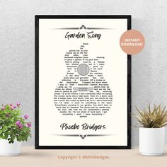 a framed poster with the words garden song on it next to some potted plants