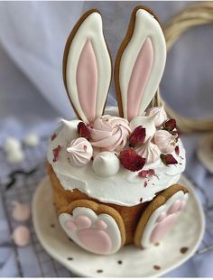 there is a cake decorated with bunnies and flowers on the top, as well as bunny ears