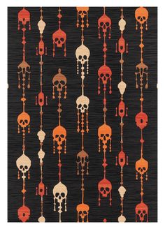 a black rug with orange and red skulls on it