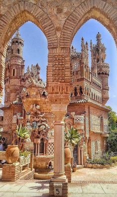 an old building with arches and statues in front of it