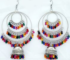 Circular earrings in three steps in silver-tone with multicolor beads inserts. It is a concentric design with a bell that has detailing around it with colorful beads hanging from it. Multicolor Metal Earrings For Festivals, Multicolor Metal Festival Earrings, Multicolor Metal Dangle Chandelier Earrings, Multicolor Metal Chandelier Earrings, Silver Earrings With Colorful Beads, Festive Multicolor Chandelier Earrings For Pierced Ears, Multicolor Metal Earrings With Dangling Beads, Multicolor Metal Jewelry With Dangling Beads, Traditional Multicolor Beaded Earrings Nickel Free