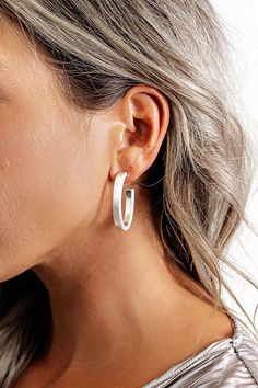 - You are sure to catch feelings for these stylish earrings! - Matte silver colored material - Oval shaped hoops with a post back White Minimalist Metal Hoop Earrings, Everyday White Metal Hoop Earrings, Trendy Silver Wrap Earrings, Trendy Silver Wrap Earrings For Everyday, Trendy White Sterling Silver Hoop Earrings, Trendy Everyday Silver Wrap Earrings, Catching Feelings, Catch Feelings, Stylish Earrings