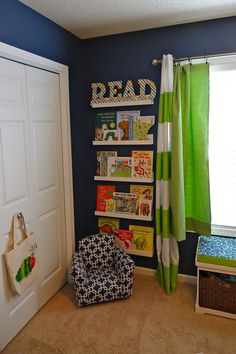 a child's bedroom with blue walls and green curtains