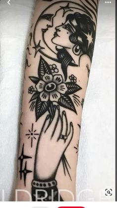 a woman's hand holding a flower tattoo on her arm