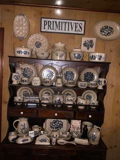 an old china cabinet is filled with blue and white dishes