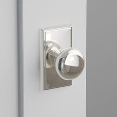 a white door with a silver knob on the side and a light bulb in the middle