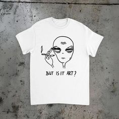 "👽😴 Explore the existential with our \"But Is It Art?\" T-shirt featuring a tired alien! 😴👽 👕 Perfect for pondering the deeper questions of existence, our T-shirt showcases a weary alien contemplating with the thought-provoking phrase \"But Is It Art?\" 🎨 Made with high-quality materials for comfort and durability, our T-shirt combines style with a touch of cosmic curiosity. Whether you're an art enthusiast or just enjoy questioning the nature of creativity, this tee is sure to spark conve But Is It Art, Funny Alien, Art Alien, Art Enthusiast, Aliens Funny, Beige Shirt, Meme Tshirts, Art Fashion, T Shirt Funny