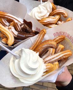 three baskets filled with different types of desserts on top of white paper wrappers