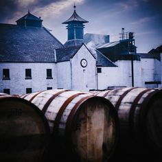 several wine barrels in front of a building