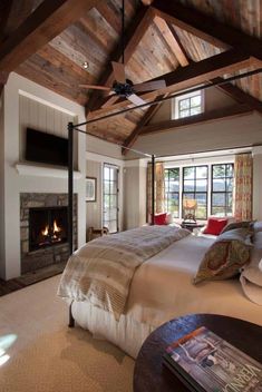 a large bedroom with a fireplace in the corner