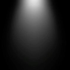 a black and white photo of a light in the middle of a dark room with no one on it