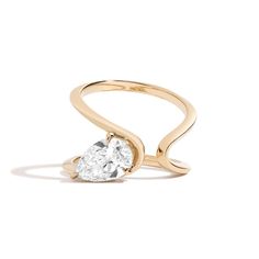 Inspired by Zaha Hadid, this Shahla lab-created diamond solitaire ring showcases a distinctive fluid design. 14K gold The 1-1/2 ct. pear-shaped lab-created diamond solitaire is nestled sideways inside the curve Certified lab-created diamond; F color/VS2 clarity Includes certification card Fits true to size Each item is custom made and not eligible for returns Pear Shaped Diamond Ring, Engagement Ring Shapes, Pear Engagement Ring, Wrap Ring, Zaha Hadid, Pear Shaped Diamond, Pear Diamond, Rough Diamond, Wrap Rings