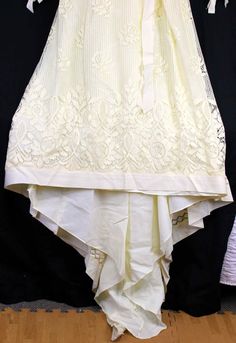 "Ivory dress, heavy-weight polyester lined with a cotton type of lace Grosgrain ribbon trim, sweetheart neckline under the lace. Ribbon around waist with long ribbon strands hanging from waist. Long sleeves with ribbon gathered cuffs. High neckline with dainty flower embroidered trim Train comes to a V like point On left-back arm seam, there is some lace stitching that has loose strands. Metal zipper closure No tags anywhere, appears to be handmade Woman's Size 6/8 based on measurements Approx m Cream Lace Trim Dress With Sweetheart Neckline, Cream Dress With Lace Trim And Sweetheart Neckline, Sleeveless Lace Dress With Contrast Lace For Wedding, Sleeveless Contrast Lace Wedding Dress, Fitted Lace Dress With Contrast Lace For Wedding, Fitted Contrast Lace Wedding Dress, Cream Lace Bridesmaid Dress With Lace Bodice, Cream Lace Bodice Dress For Bridesmaid, Off White Lace Wedding Dress For Spring