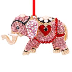 an elephant ornament hanging from a red ribbon on a white background with the word love