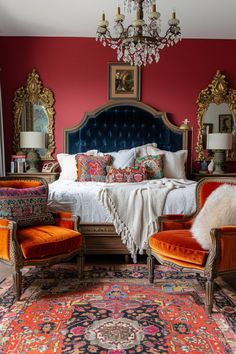 an ornate bedroom with red walls, gold accents and colorful rugs on the floor