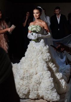 the bride is walking down the aisle in her wedding dress