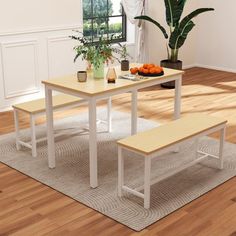 a table with two benches next to a potted plant on top of a rug