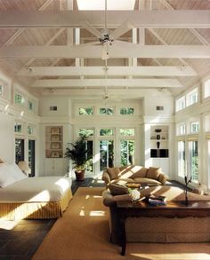 the sun shines through the windows in this living room with couches and chairs