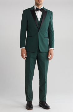 Bring understated elegance to the table in this three-piece tuxedo crafted from rich fabric in a classic single-breasted silhouette. Jacket has shawl collar; chest welt pocket; front welt pockets Vest has front button closure; V-neck Pants have zip fly with button closure; front slant pockets; back button-welt pockets Jacket and vest are lined; trousers are lined to the knee 65% polyester, 35% viscose Dry clean Imported Classic Fitted Tuxedo With Suit Collar, Tailored Green Tuxedo Suit, Classic Notch Lapel Suits For Party, Fitted Single Button Tuxedo For Black Tie Events, Fitted Single Button Tuxedo For Black Tie, Formal Fitted Three-piece Suit, Elegant Fitted Sets With Suit Collar, Green Slim Fit Tuxedo For Formal Occasions, Green Slim Fit Suit For Formal Occasions