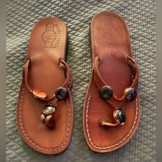 Cognac Thongs With Born Brown Round Stone Accents Never Worn Too Big Europian Size 40 Fits More Like 8/8.5 Leather Footbed Toe Loop Flip Flops For Beach, Brown Single Toe Strap Flip Flops For Vacation, Toe Loop Flip Flops With Leather Footbed For Beach, Leather Round Toe Flip Flops For Beach, Leather Footbed T-strap Flip Flops For Vacation, Leather Toe Post Flip Flops For Summer, Leather Toe Post Summer Flip Flops, Summer Leather Toe Post Flip Flops, Leather Flip Flops With Round Toe For Vacation