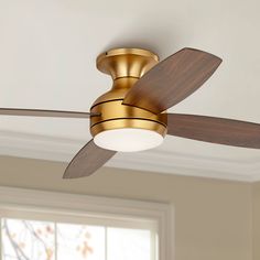 a ceiling fan with a light on top of it in a room next to a window