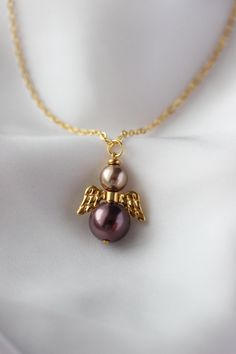 Beautiful necklace with finest quality European crystal brown-purple color, light brown pearl coated 12 and 8 mm beads, gold tone jewelry metal alloy wings separator and gold tone stainless steel chain with gold tone lobster claw. The chain is from lead & nickel free metal. Lovely memorial gift for someone special! Total length of necklace is about 63.5 cm or about 25 inches. Other necklaces of my shop you can see here: https://www.etsy.com/shop/NaTavelli?section_id=14843046&ref=shopsection_left Purple Pearl Chain Jewelry For Gift, Brown Beaded Pearl Necklace Gift, Brown Round Beads Pearl Necklace Gift, Brown Pearl Necklace Gift, Brown Pearl Necklace With Round Beads As Gift, Brown Pearl Necklace With Round Beads For Gift, Purple Pearl Chain Necklace As A Gift, Handmade Brown Pearl Necklace Gift, Brown Beaded Pearl Necklace For Gift