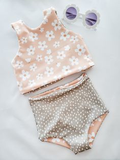 Versatile, comfortable, reversible, and oh so adorable. What more could you want in a swimsuit?!I'm so excited to introduce you to my brand new daisy floral and sage green polka dots swimsuit! The main print features super cute white daisies set against a peachy background. The coordinating polka dot fabric is a sage green with white dots.The best part of this swimsuit is that both top and bottom are fully reversible! You get multiple swimsuit looks in one!The bottoms are a trendy high waisted d Cute Spring Beach Tankini, Cute Summer Tankini For Playwear, Spring Playful Tankini For Swimming, Cute Spring Tankini For Poolside, Spring Beachwear Swimwear For Play, Cute Summer Tankini For Poolside, Fitted Playful Floral Print Swimwear, Cute Summer Tankini For Casual Wear, Playful Fitted Floral Print Swimwear