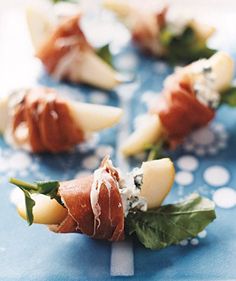 small appetizers are arranged on a blue plate