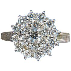 Sparkling Circular Cocktail Cluster Diamonds ring. 1.10ct Diamonds Full cut, Rounds Mounted Within prongs & Channel on band G color, Vs-2 clarity marked 18kt. white gold 5.5 Grams Deck of Ring is .51 Inch diamter .40 Inch depth current size: 6.75 We may resize (please inquire). Completely hand made with precision. $4000 appraisal certificate will accompany Floating Diamond Ring, Triple Ring, Diamonds Ring, Diamond Cocktail Rings, Heart Pendant Diamond, Diamond Cluster Ring, Emerald Diamond, Emerald Ring, Diamond Heart