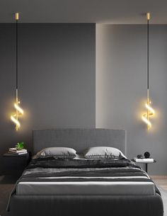 a bed with two lights hanging from it's headboard in a gray bedroom