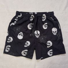 Express Your Gothic Style With These Romwe Shorts Featuring A Skull And Spider Web Graphic Design. The Drawstring Waist And Elastic Waistband Provide A Comfortable Fit, While The Lightweight Material Is Perfect For Any Season. These Unisex Shorts Also Come With Slash Pockets To Store Your Essentials While On The Go. Ideal For Travel And Casual Occasions, These Mid-Rise Shorts Have A 6-Inch Inseam And Fit Athletic Bodies. Made Of 97/3 Polyester/Elastane Material, They Are Machine Washable For Eas Black Rave Style Shorts, Black Rave Style Short Bottoms, Black Rave Bottoms For Halloween, Rave Style Black Bottoms For Halloween, Gothic Summer Shorts For Streetwear, Rave Black Shorts, Halloween Streetwear Short Bottoms, Black Shorts For Halloween Streetwear, Black Rave Bottoms