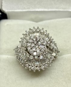 This is a new ring yet vintage from an out of biz fine jewelry store. Size 7 approx 120 diamonds equaling to two carats total diamond weight. This large cluster weigh 5.3 gms, made of 10 kt white gold , stones are round and baguette shaped, very good quality diamonds set in prong settings. A classic timeless ring which is remarkable as a dinner or cocktail ring, an engagement ring or an April birthstone. Sparkly and exquisite! Diamond White Diamond Ring With Baguette Diamonds, Exquisite Cluster Diamond Wedding Ring, Exquisite Cluster Diamond Ring For Wedding, Diamond White Baguette Diamond Ring, Luxury Brilliant Cut Cluster Ring, Diamond Cluster Ring In Fine Jewelry Style, Diamond White Ring With Baguette Diamonds, Luxury Cluster Ring With Baguette Diamonds, Luxury Baguette Diamond Cluster Ring With Round Cut