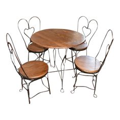 a set of four metal and wood heart shaped dining tables with matching chairs, one in the shape of hearts