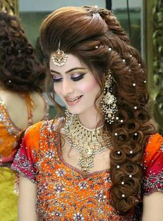 a woman with long hair wearing an orange dress