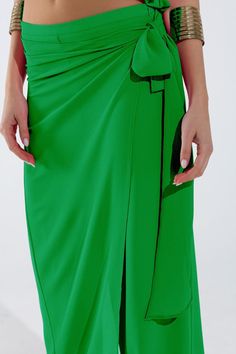 Introducing our Wide Green Pants Overlay Skirt, a stunning and versatile piece perfect for adding a touch of elegance to your party attire. This maxi-length overlay skirt features wide legs and a relaxed fit, providing both comfort and sophistication for any occasion.  Crafted from lightweight chiffon fabric, this overlay skirt drapes beautifully and flows with every movement. The knot detail at the side adds a chic and stylish touch, while the zip side closure ensures easy wear.  Perfect for parties or special events, this skirt can be paired with a variety of tops to create different looks. Made from 100% polyester with a polyester lining, it is durable and easy to care for, making it a practical choice for your wardrobe.  Our model is wearing size S, but the S-M-L sizing corresponds to Chiffon Pants, Overlay Skirt, Party Attire, Skirt Jumpsuit, Scarf Headband, Chic Top, Green Pants, Wide Legs, Romper Pants