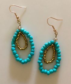 These multicolored double teardrop earrings are made of a variety of seed beads and ear wire. Customizable. Turquoise Teardrop Earrings With Faceted Beads, Turquoise Teardrop Earrings With Tiny Beads, Adjustable Beaded Turquoise Teardrop Earrings, Bohemian Dangle Teardrop Earrings With Faceted Beads, Blue Beaded Teardrop Chandelier Earrings, Gold Teardrop Earrings With Colorful Beads, Teardrop Beaded Earrings For Jewelry Making, Teardrop Beaded Earrings With Faceted Beads, Handmade Turquoise Teardrop Earrings With Round Beads