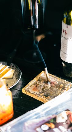 a bottle of wine and some food on a table