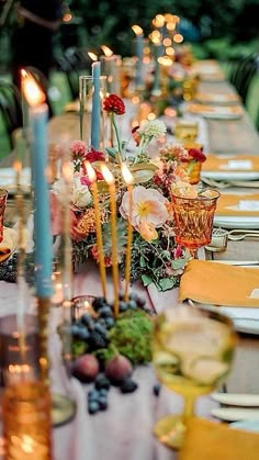 a long table is set with candles and plates