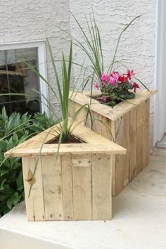 two wooden planters with plants in them