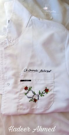 an embroidered shirt with flowers on it and the words, amana astarr written in cursive writing