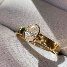 a gold ring sitting on top of a white cloth