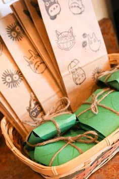 some paper bags tied up and sitting in a wicker basket on top of a table